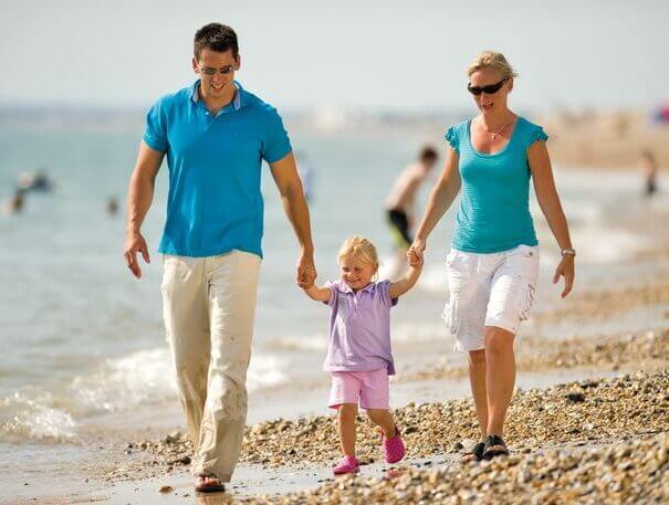 family-walk-on-the-beach